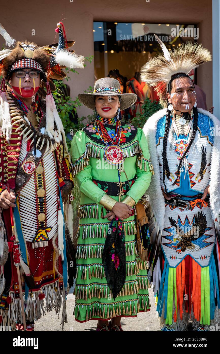 Native Americans in traditional dress stroll the Santa Fe Plaza in New ...