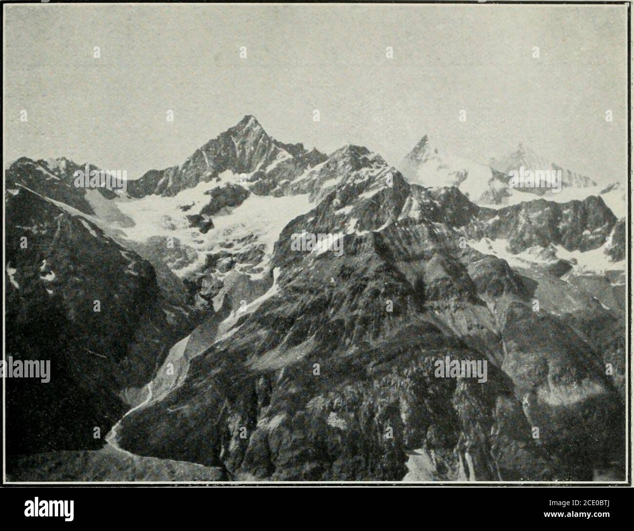 . Sierra Club bulletin . bscured the summit of the Matterhorn.It was a most impressive thing, during a few sunlithours of the day, to watch cannonades of rock comedown the east face and bound out with a fearful roarupon the Furggen Glacier. Rocks acquire frightful mo-mentum on the sides of the Matterhorn. During a partof the way their path from a distance is visible only bythe puffs of smoke that rise where they strike. At nightthey leave a long trail of fire. This and the infernal noisewhich accompanies them leave no doubt in the mind ofthe ignorant Swiss peasant that the devil beguiles hisle Stock Photo
