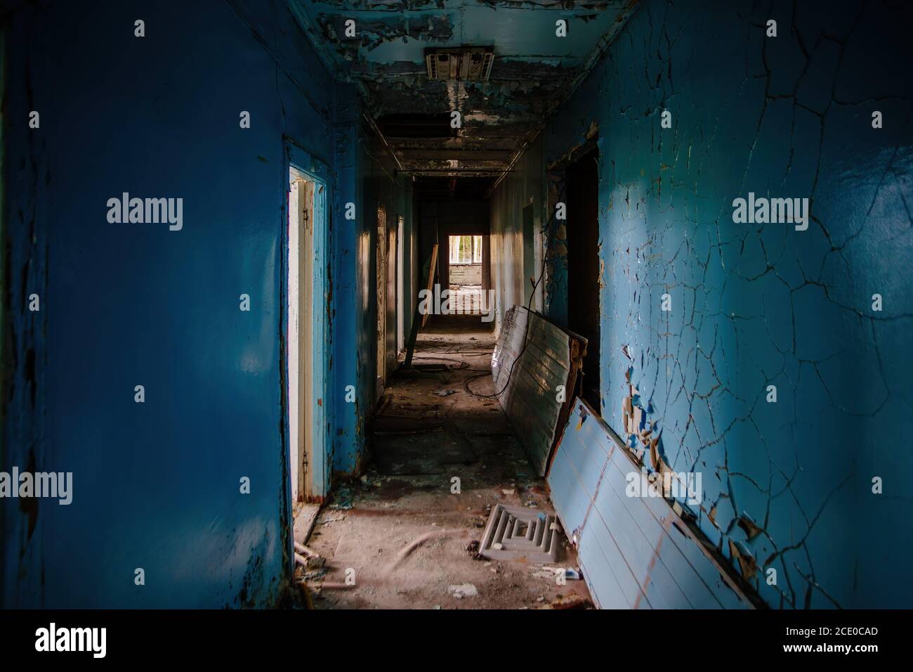 Dark creepy empty corridor of abandoned industrial or office building Stock Photo