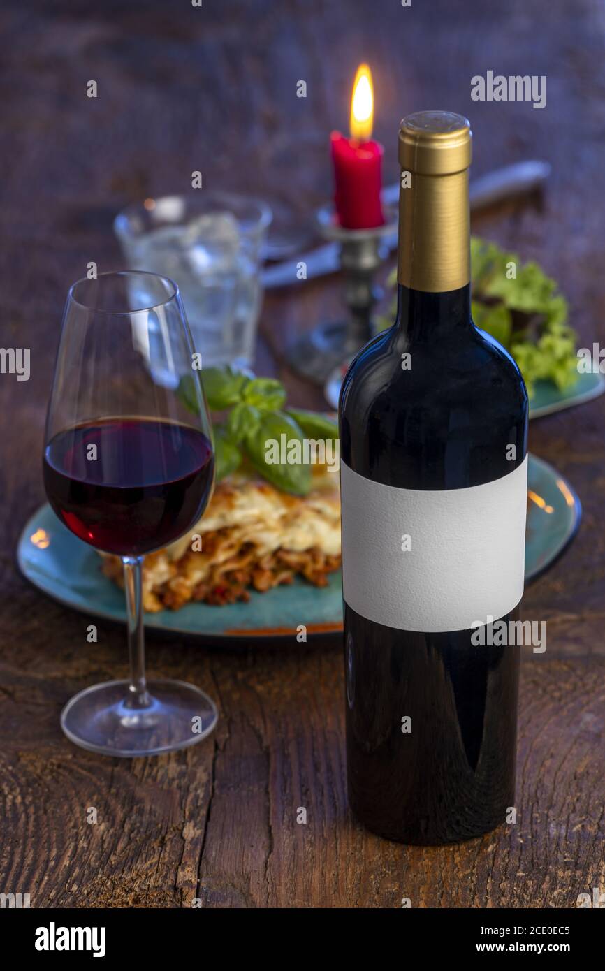 Red wine and lasagne on wood Stock Photo