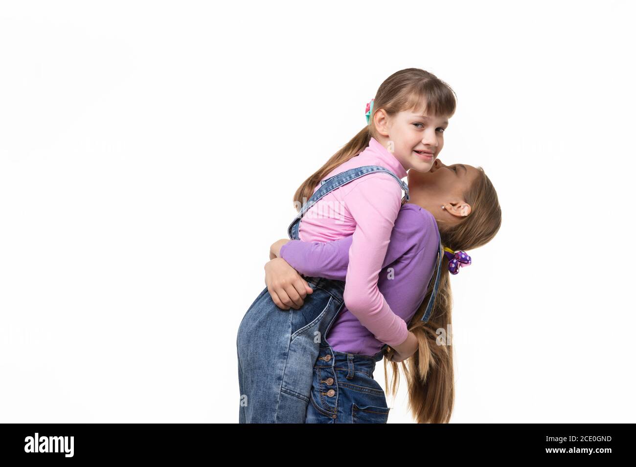 Girl lifted and hugged another a girl Stock Photo