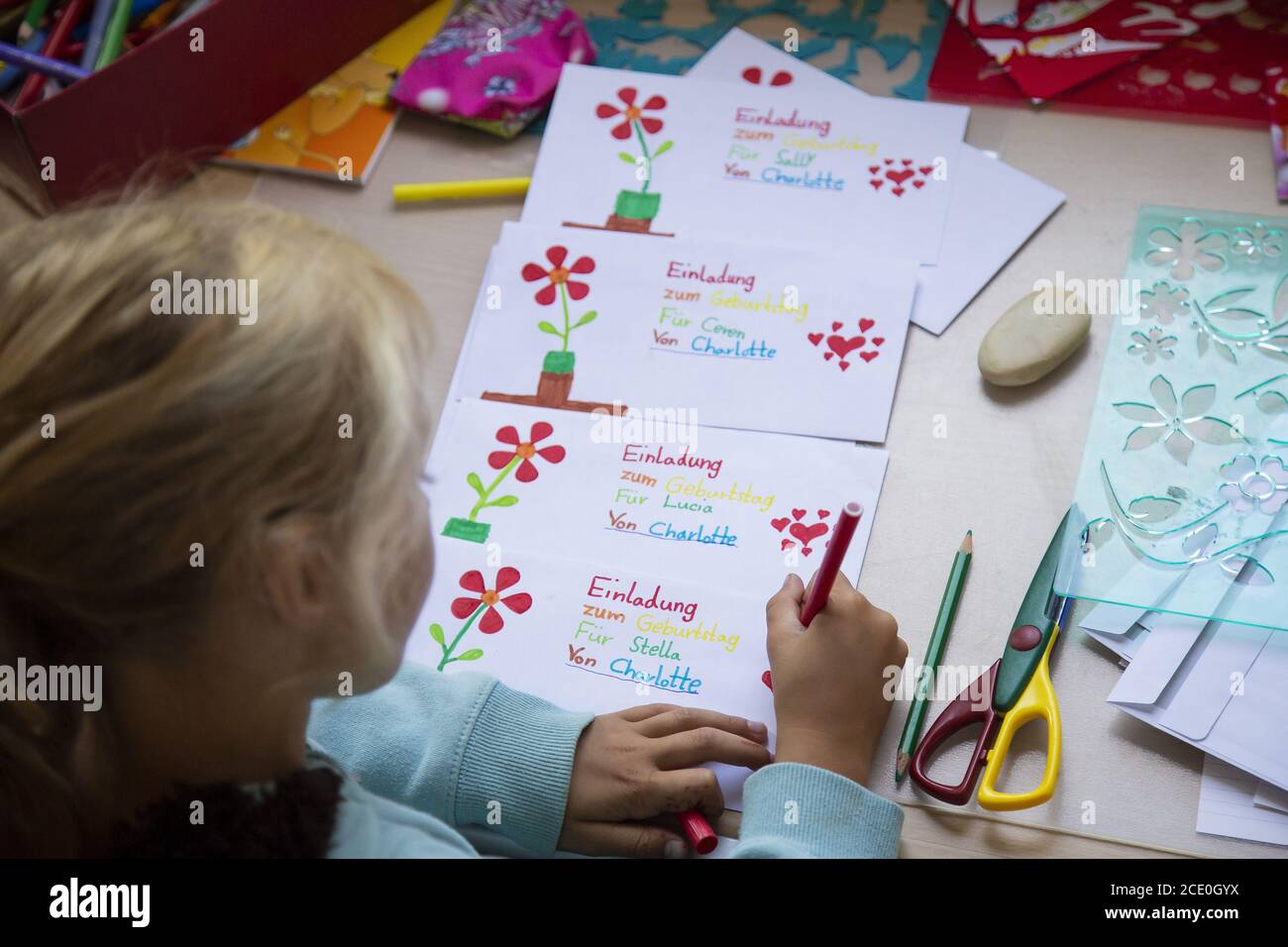 Girl (7) paints invitation cards with felt-tip pens, Kiel, Schleswig-Holstein, Germany Stock Photo