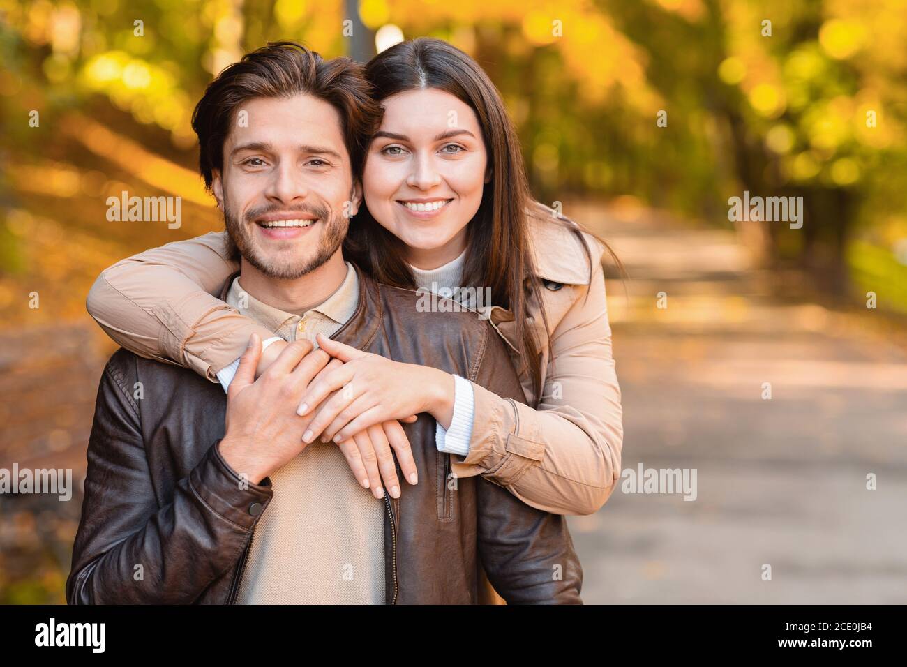 Family portrait of young couple posing at forest Stock Photo - Alamy