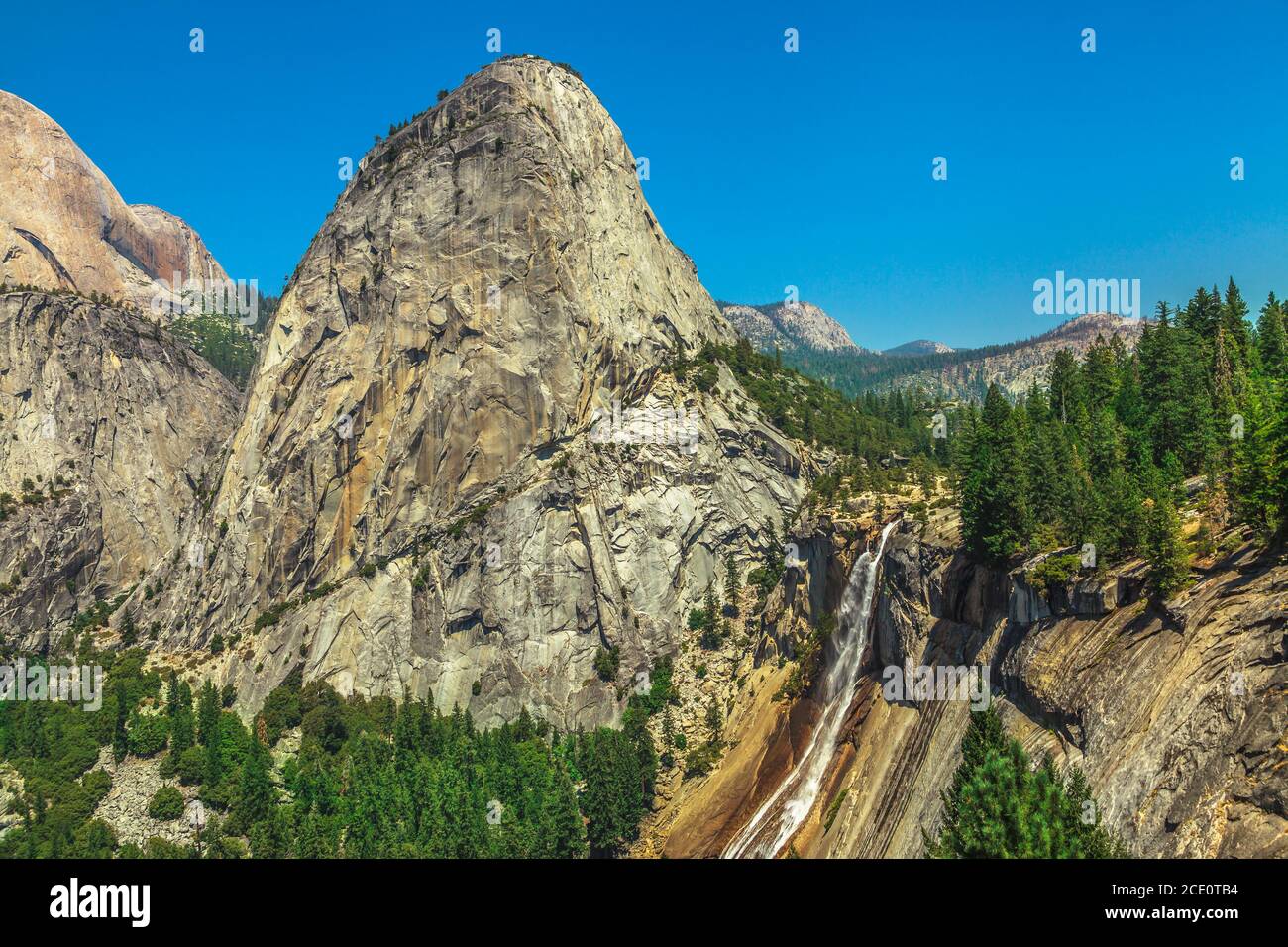 top view of the Liberty Cap rock and Nevada Fall waterfall on Merced River from John Muir trail in Yosemite National Park. Summer travel holidays in Stock Photo