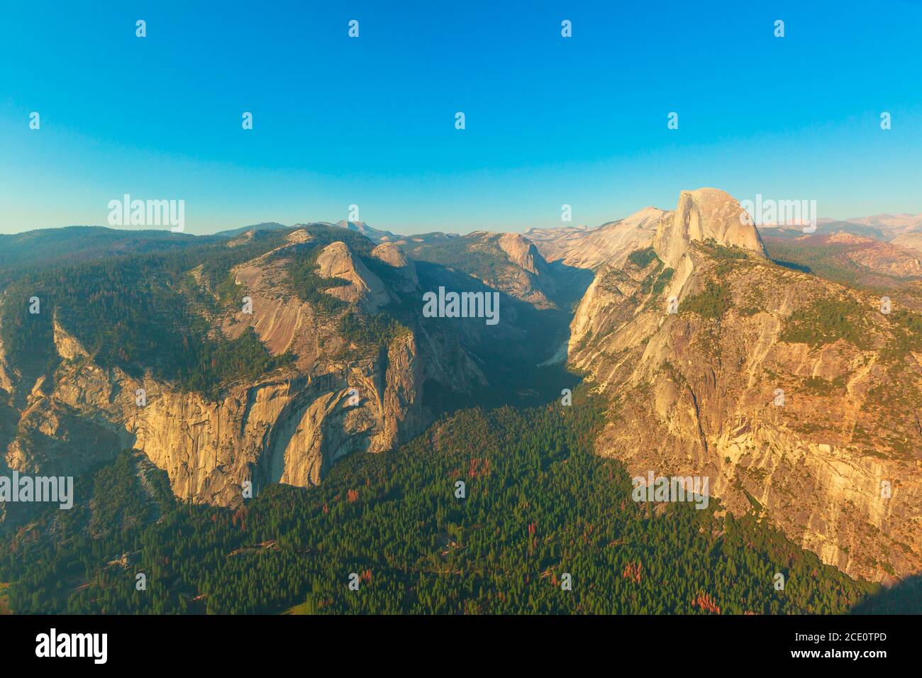 Washburn Point sunset panorama in Yosemite National Park, California, United States. View of Half Dome, Liberty Cap, Yosemite Valley, Vernal Fall, and Stock Photo