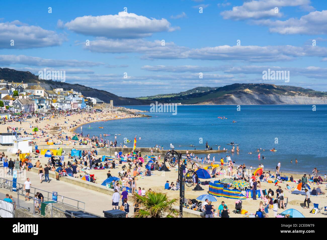 Lyme Regis, Dorset, UK. 30th August 2020. UK Weather: After a cold start crowds of staycationers, holidaymakers, beachgoers flock to the packed beach at the seaside resort of Lyme Regis on Bank Holiday Sunday to enjoy the hot sunshine. Credit: Celia McMahon/Alamy Live News. Stock Photo