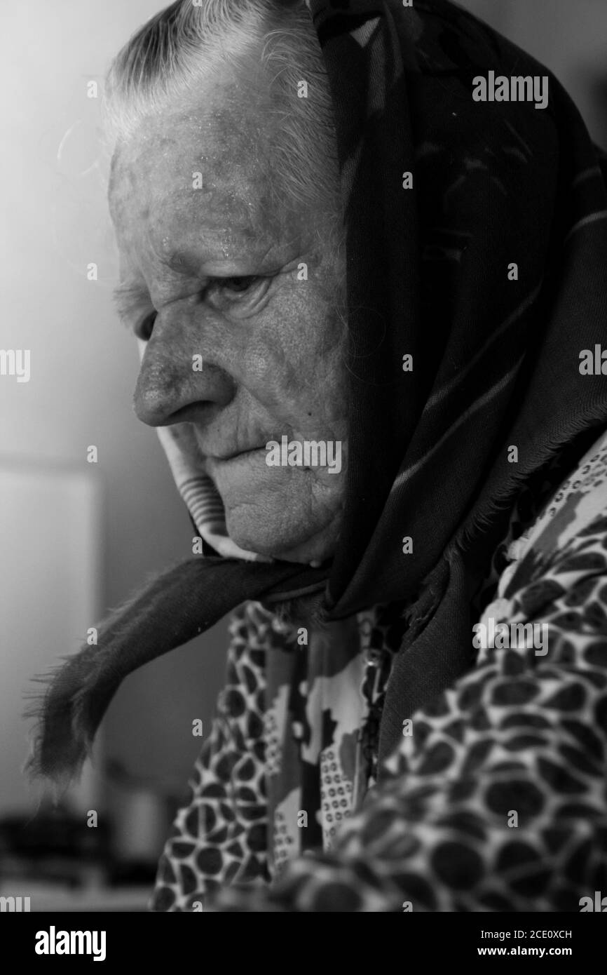 A portrait of an Old Woman, Senior, Grand mother Wearing Traditional Slovakian - middle european clothes. The black and white, artistic close up. Stock Photo