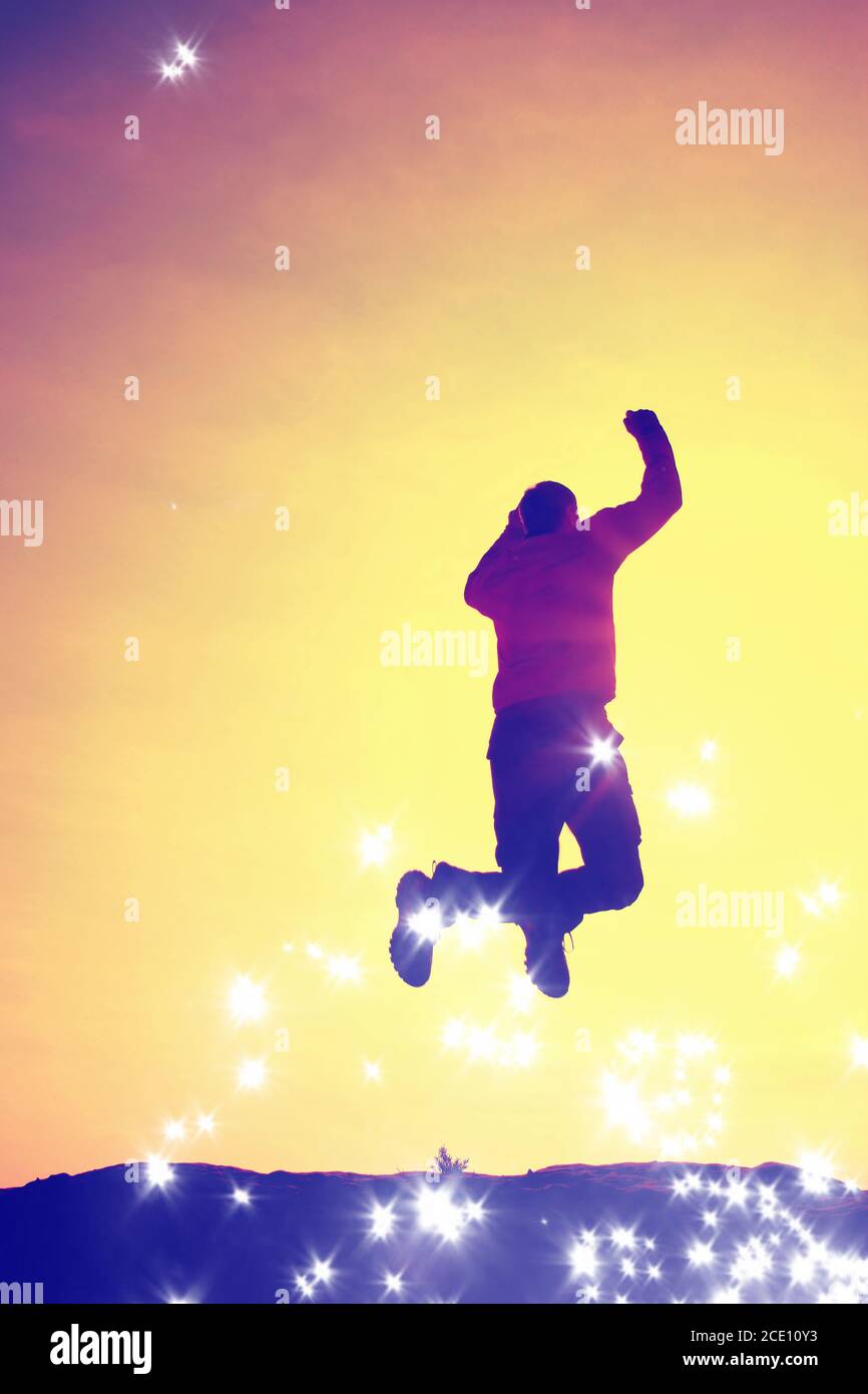 Film grain. Flying man. Young man falling down on colorful sky background. Stock Photo