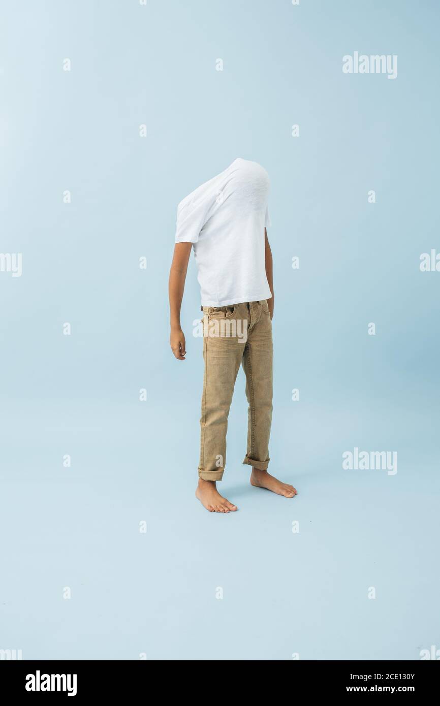 Funny ten year old kid with shirt stretched over his face Stock Photo