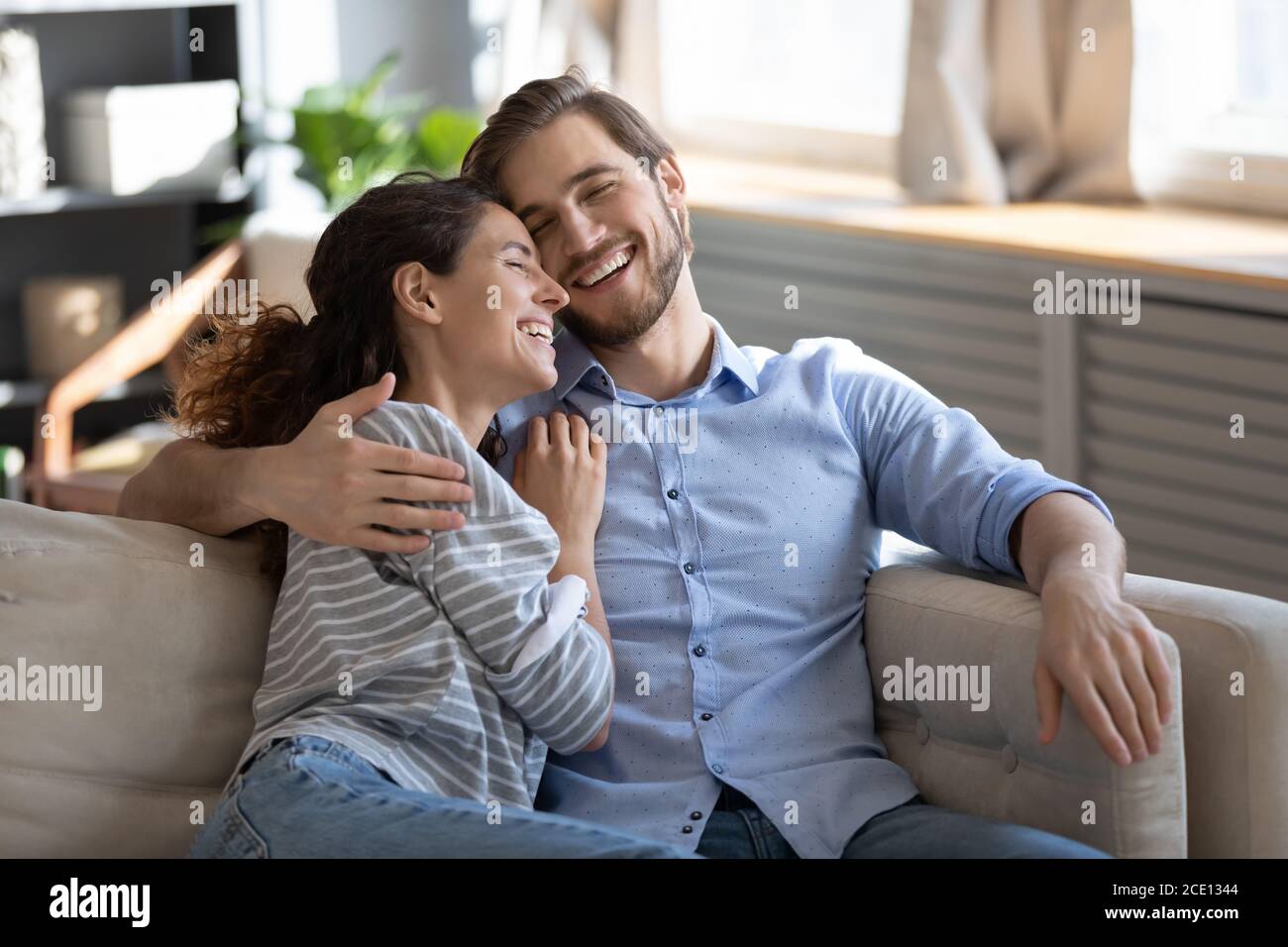 Emotional positive romantic family couple laughing at funny joke. Stock Photo