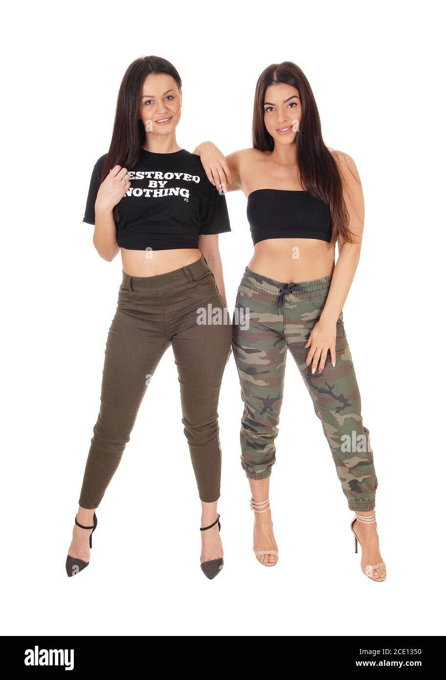 Two lovely woman standing side by side in the studio Stock Photo