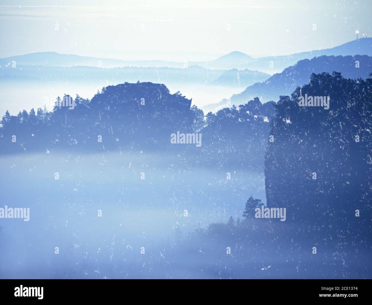 Abstract effect. Misty view into beautiful valley. Sandstone peaks in heavy fog Stock Photo