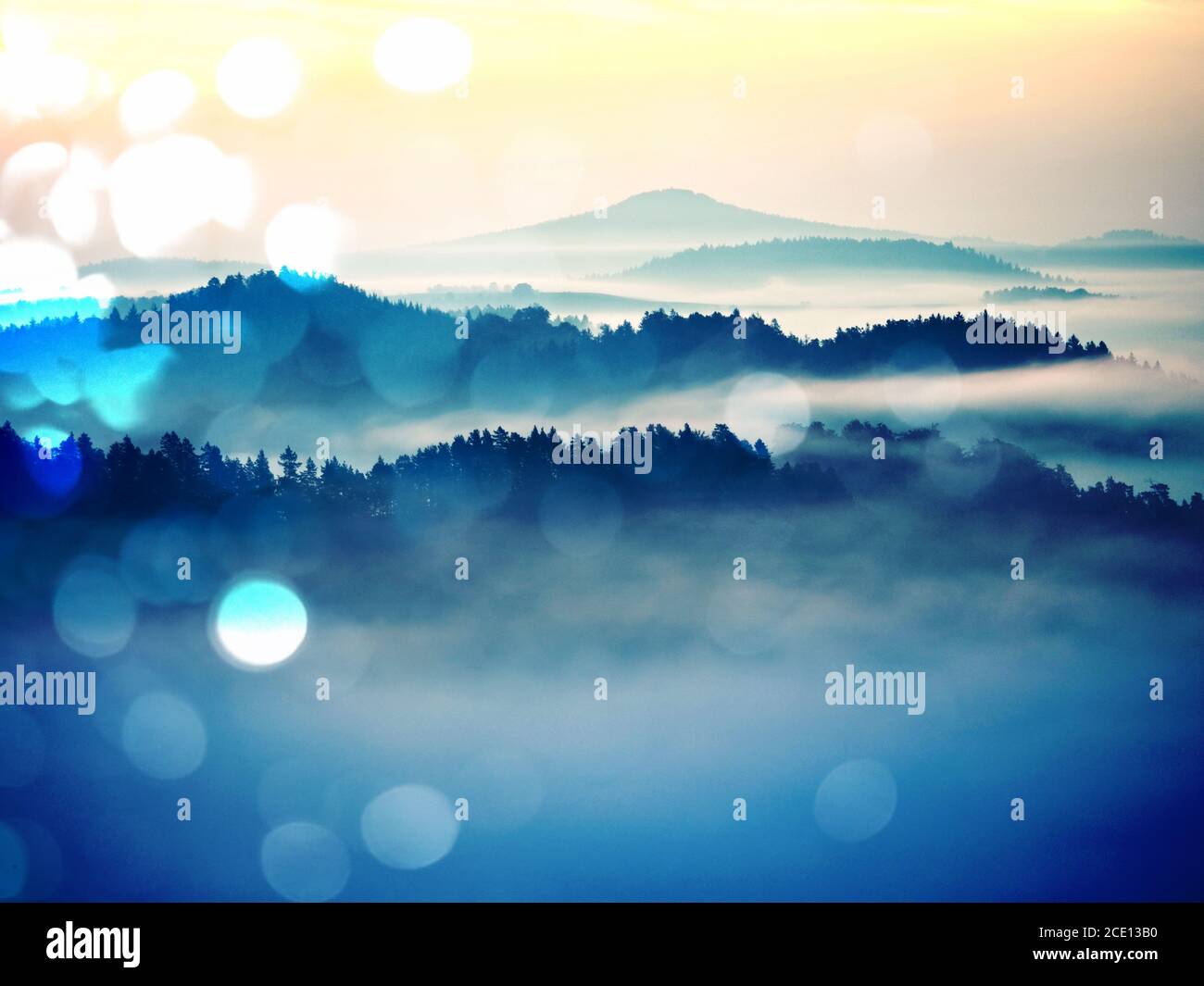 Abstract effect. Dreamy landscape lost in thick fog. Fantastic morning glowing by sunlight Stock Photo