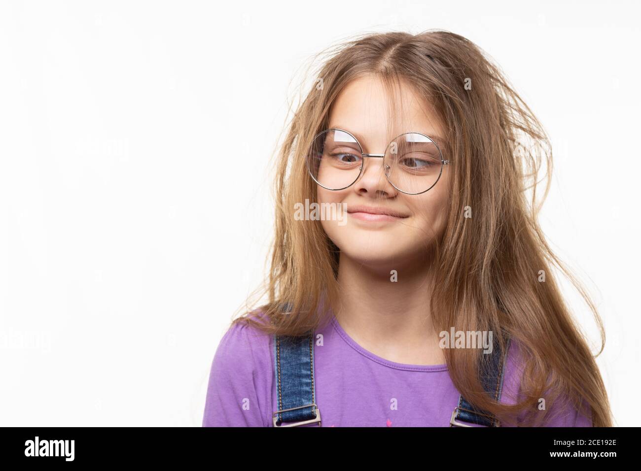 Girl with glasses trying to look at her nose Stock Photo Alamy