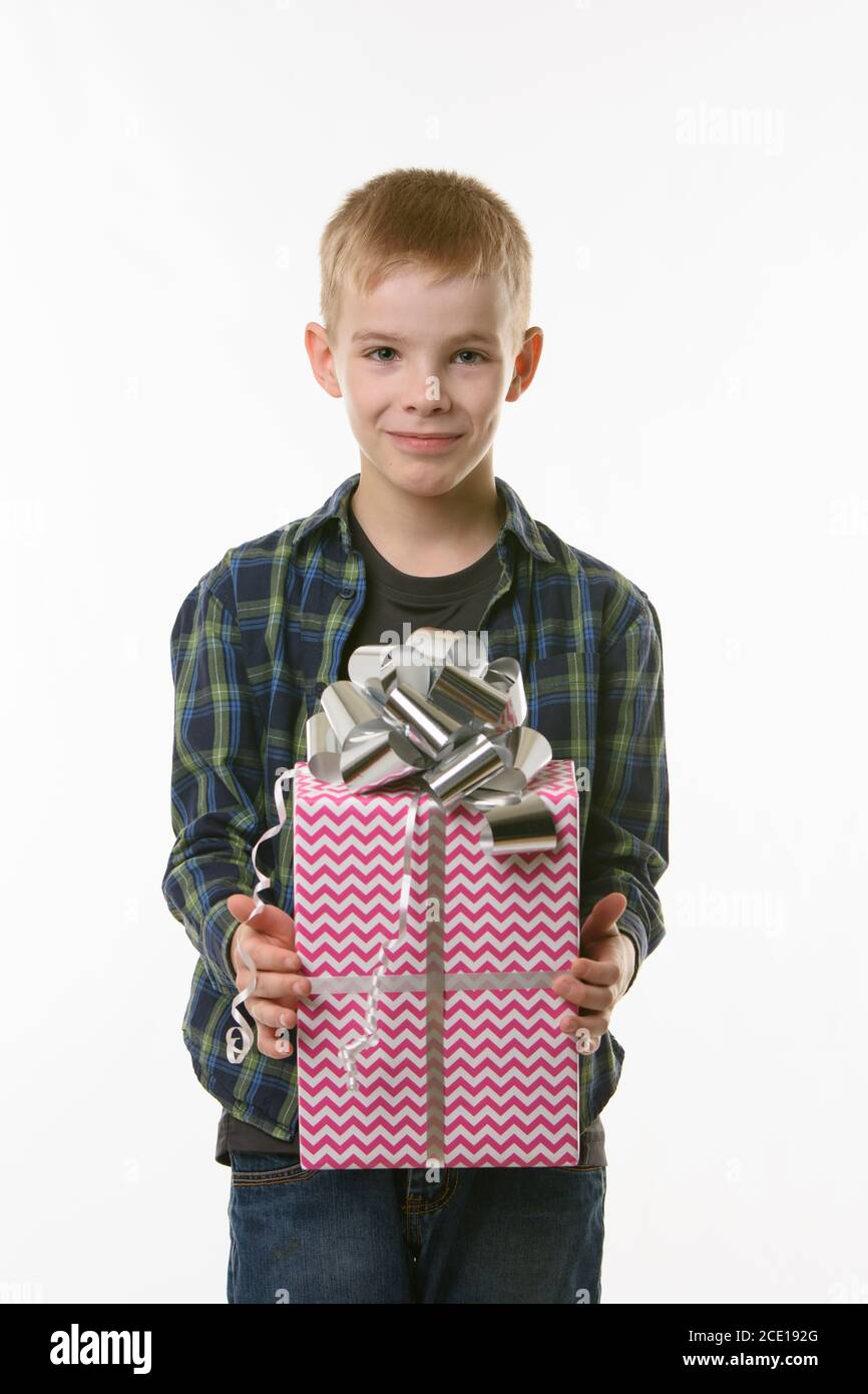 A boy holds a birthday gift in his hands Stock Photo