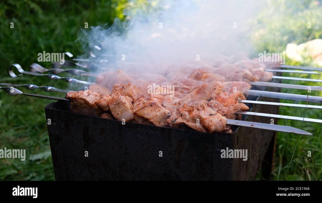 Cooking shashlik, shish kebab. Charcoal fire, cooking red meat outdoors Stock Photo