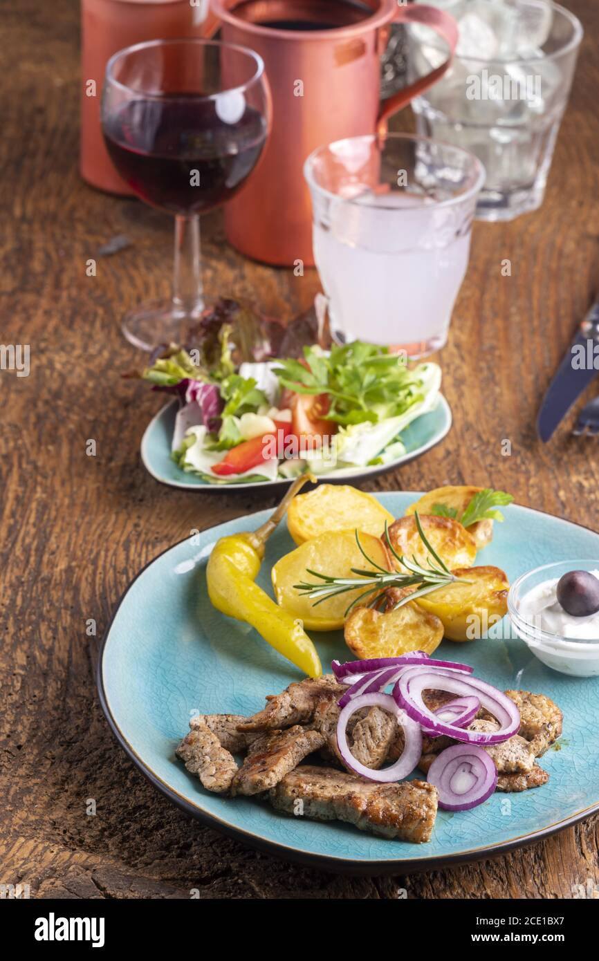 Greek gyros with salad and ouzo Stock Photo