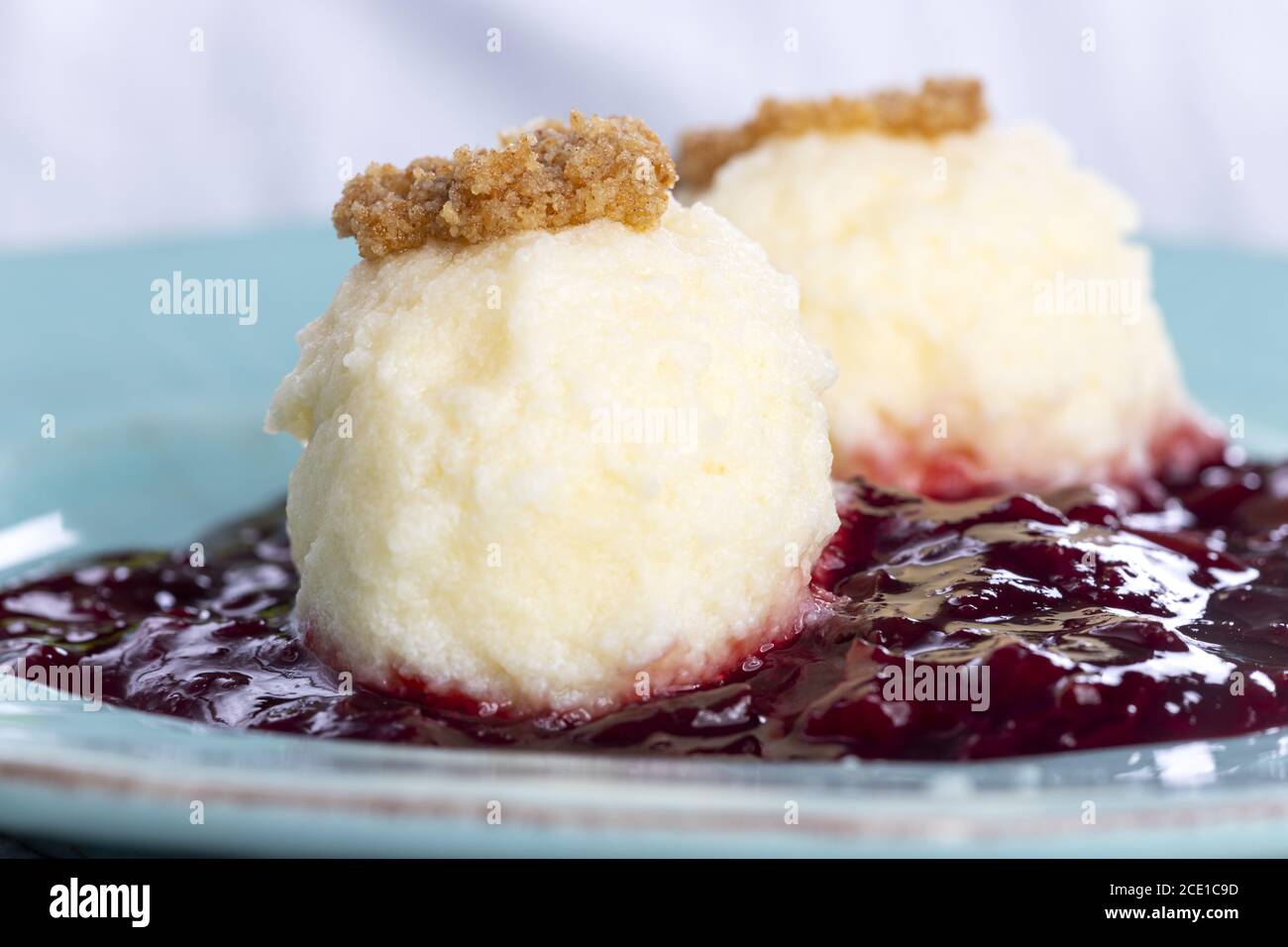 Austrian quark noodles on plum sauce Stock Photo