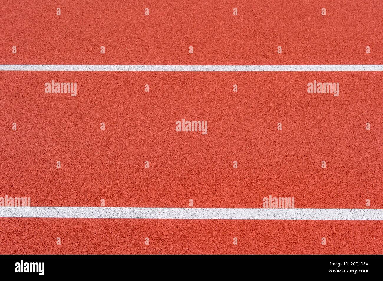 Close up on a white line in artificial red turf, on a street basketball ...