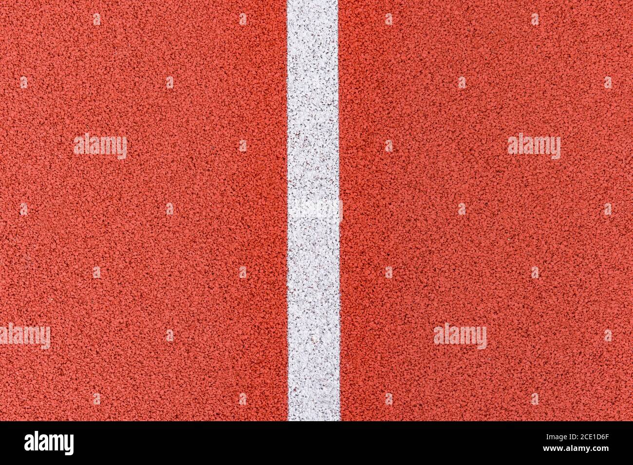 Close up on a white line in artificial red turf, on a street basketball ...