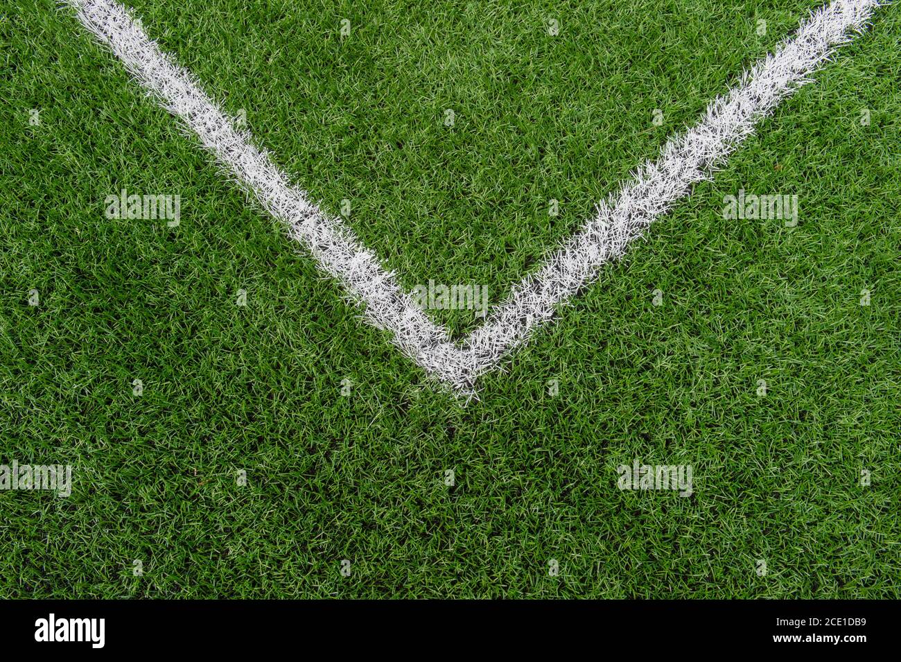 Green synthetic grass sports field with white line shot from above. Soccer, rugby, football, baseball sport concept Stock Photo