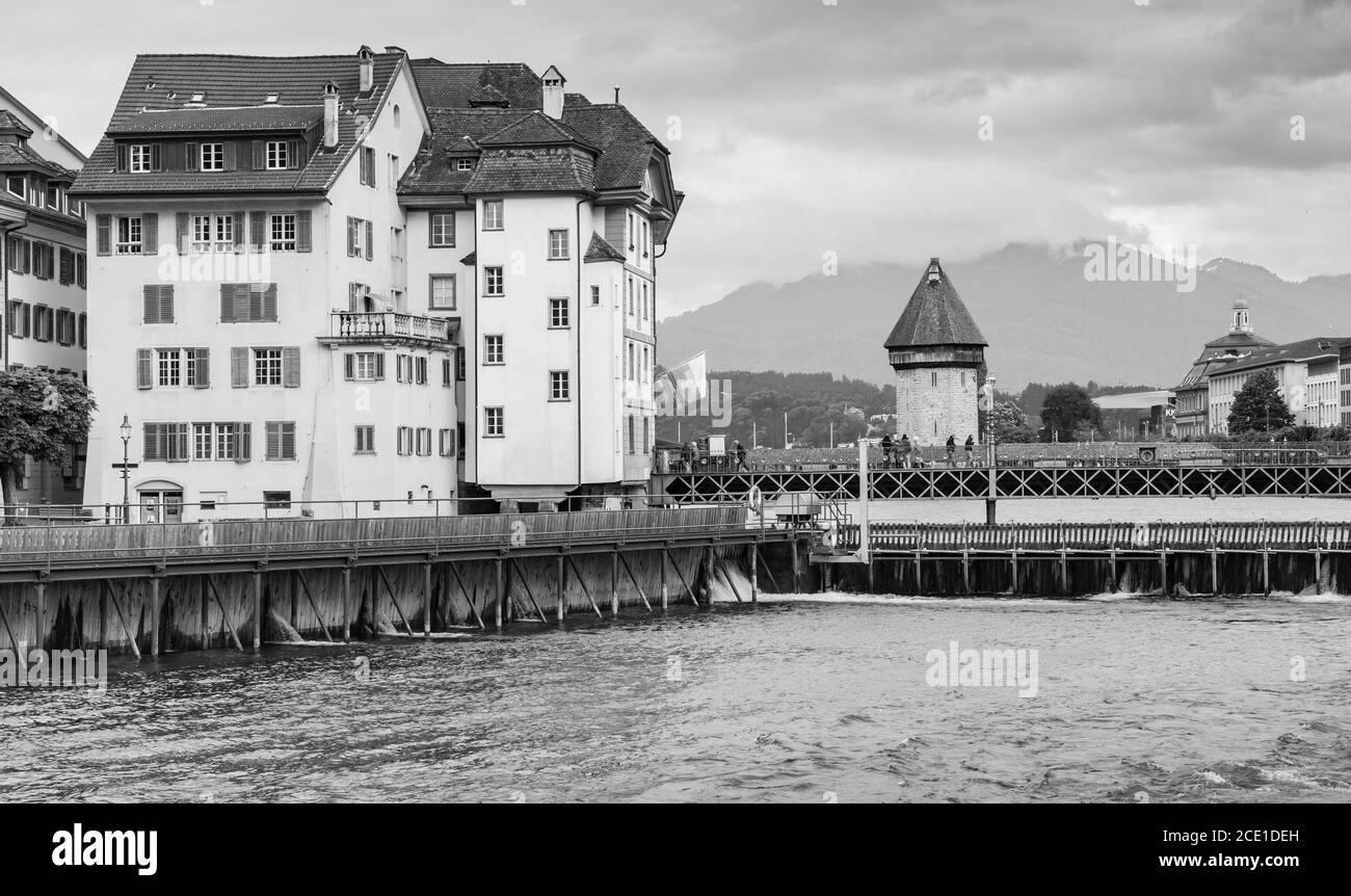 Lucerne coastal view with old living houses and ancient Water Tower. Switzerland. Black and white photo Stock Photo