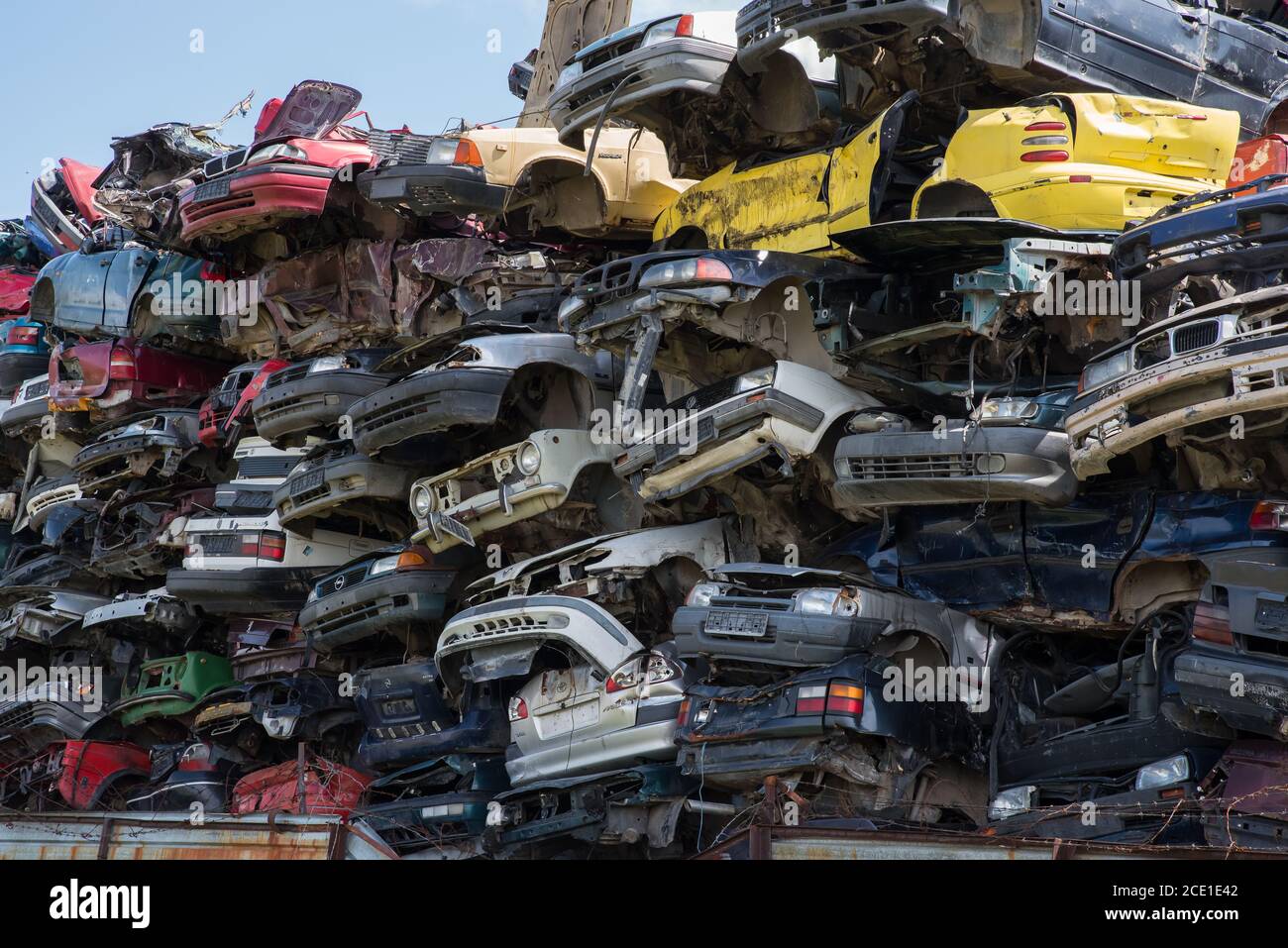 Stacked junk yard clunker cars prepared for recycled Stock Photo Alamy