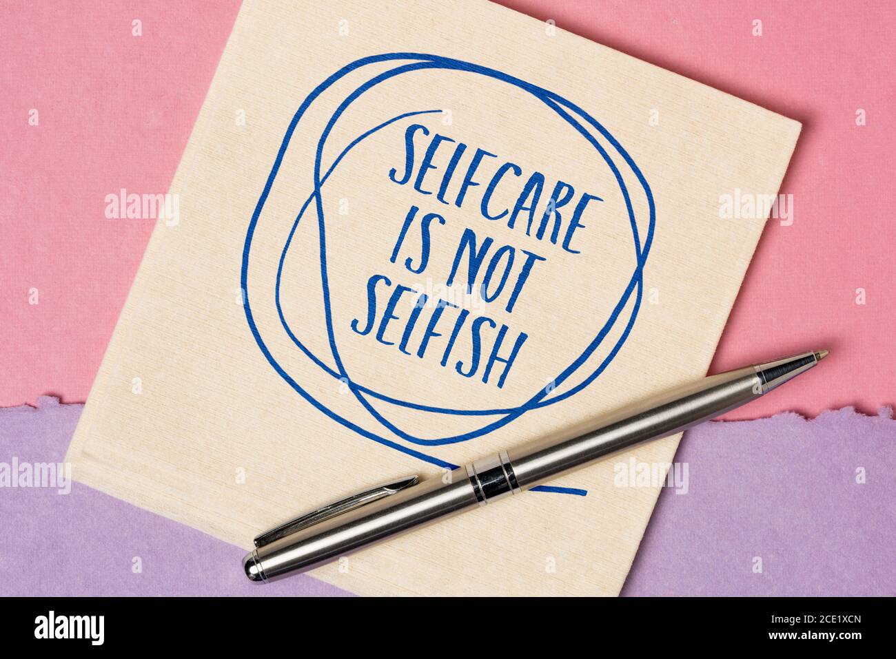 selfcare is not selfish inspirational reminder - handwriting and doodle on a napkin, body positive, mental health slogan Stock Photo