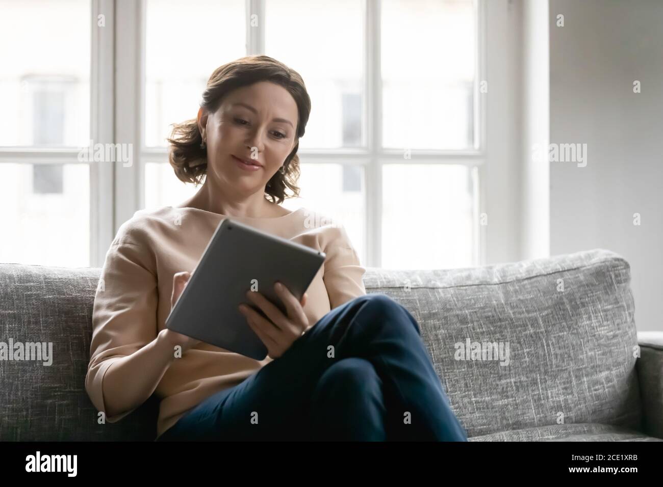 Mature woman computer home alone hi-res stock photography and images ...