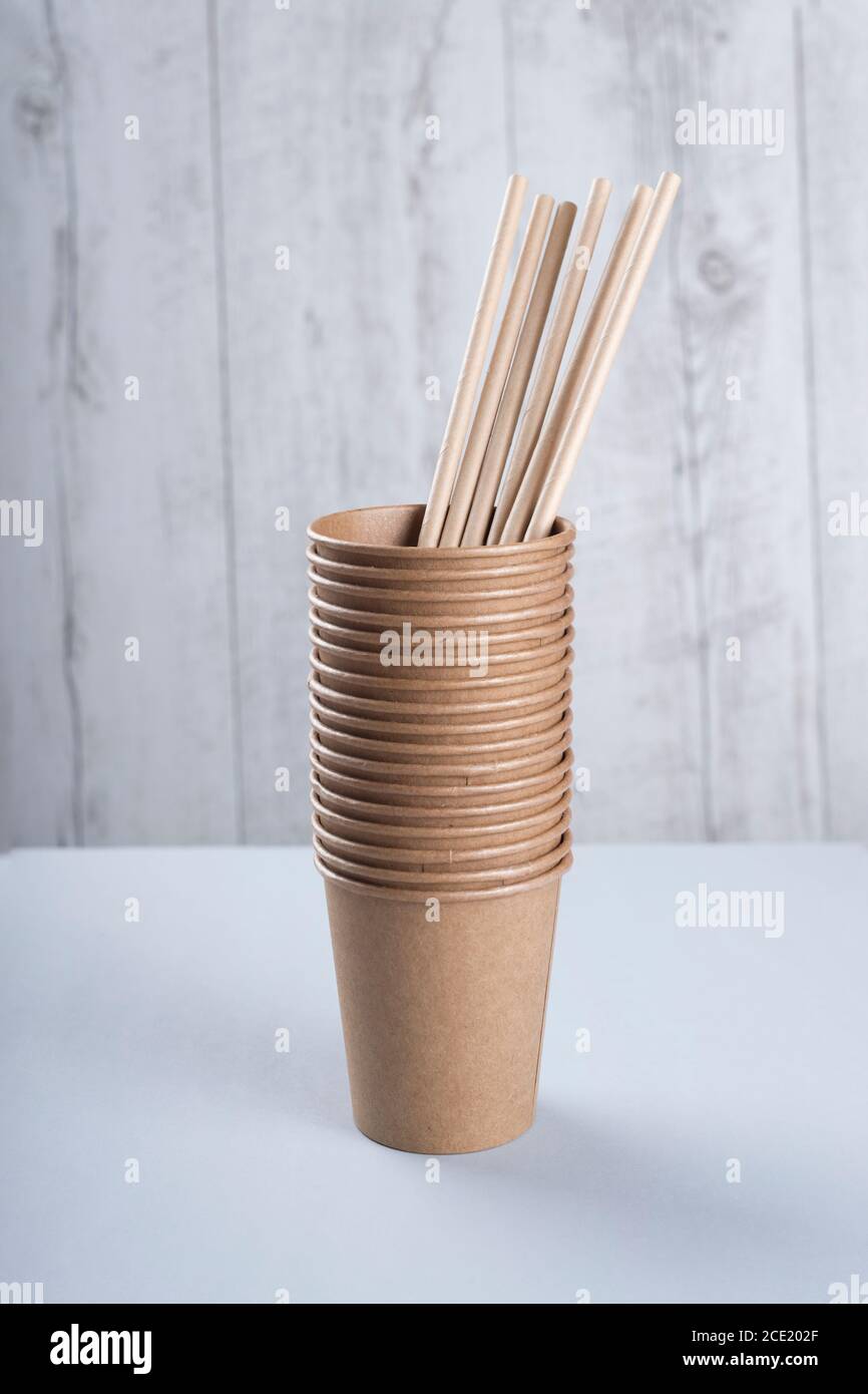 Biodegradable cups and drinking straws on light grey background Stock Photo