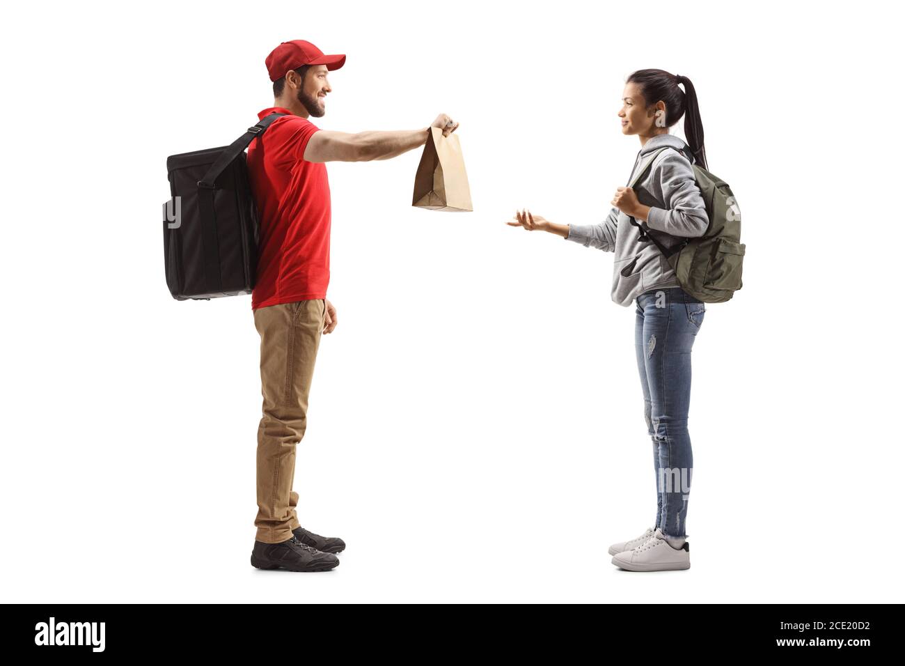 Full length profile shot of a guy delivering a food to a female student isolated on white background Stock Photo