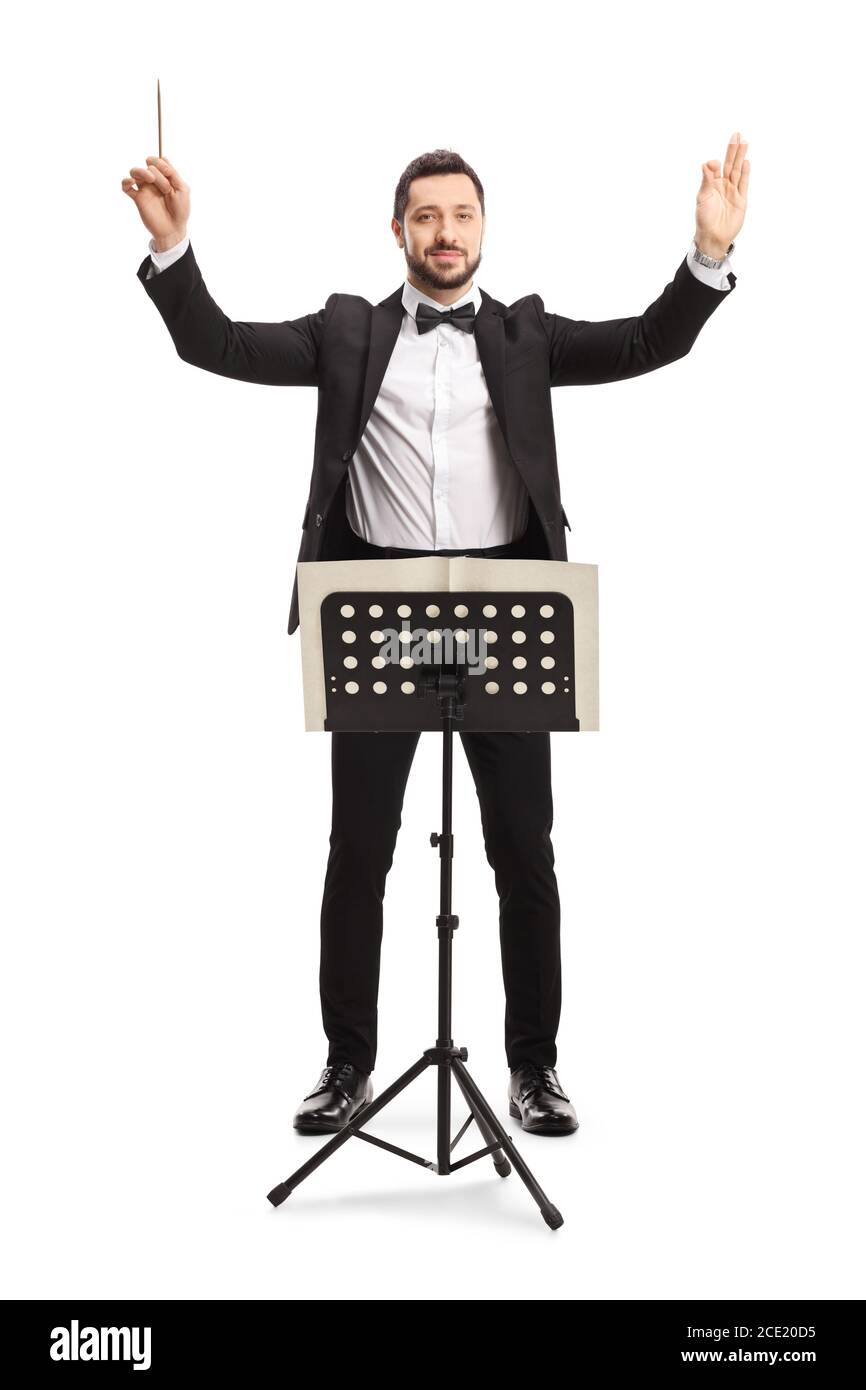 Full length portrait of a musical conductor with a baton performing with a notebook on a stand isolated on white background Stock Photo