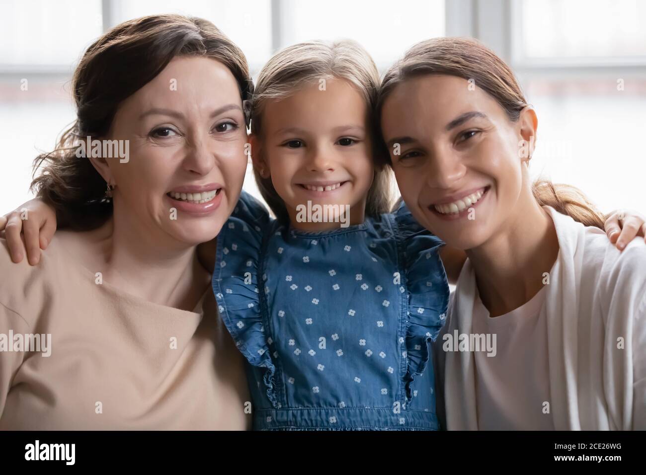 Portrait of bonding mixed race multigenerational female family. Stock Photo