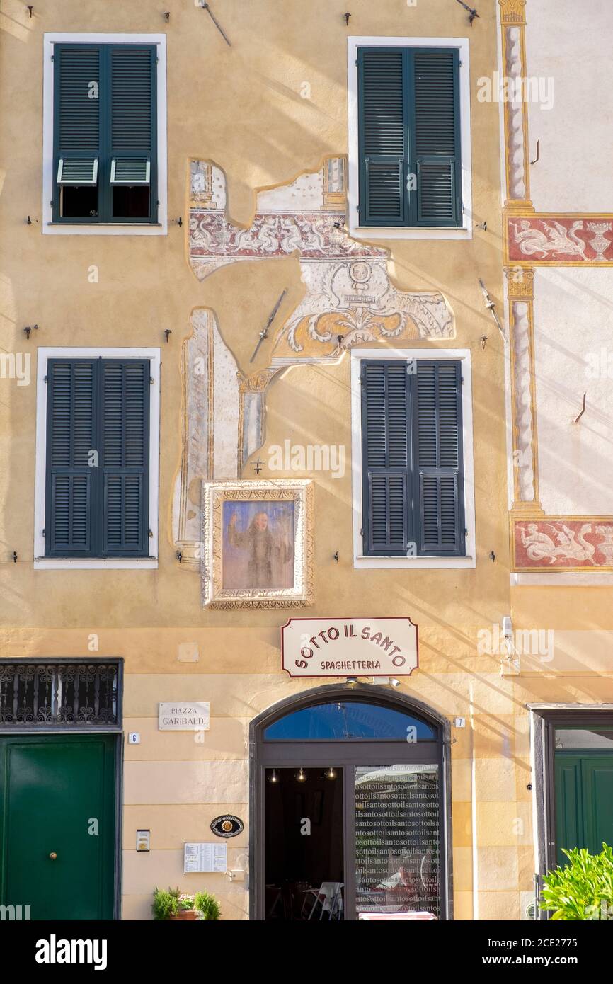 Spaghetteria restaurant and old yellow ochre  buildings in the old town of Finalborgo, Finale Ligure, Liguria, Italy Stock Photo