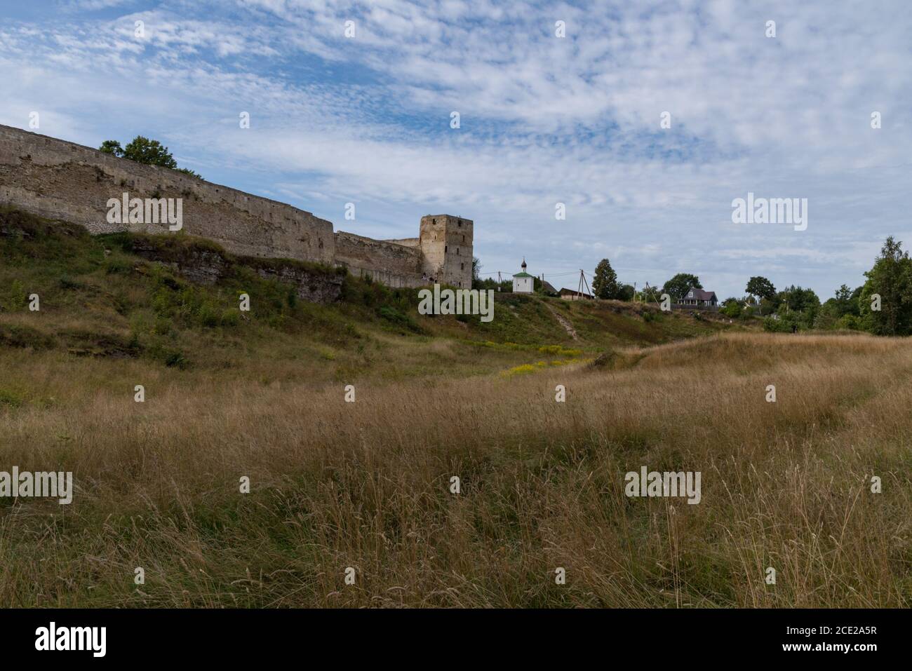 Medieval Izborsk fortress wall,  Talavskaya tower and Chapel of the Korsun Icon of the Mother of God. Izborsk, Pskov region, Russia. Stock Photo