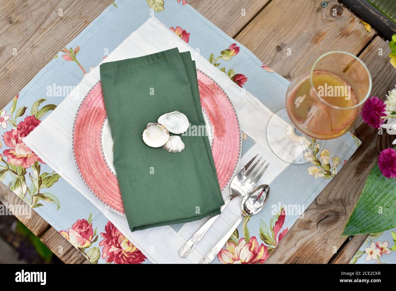 Secluded outdoor patio dining cafe with beautiful rustic garden decor for romantic summer evening dinner Stock Photo