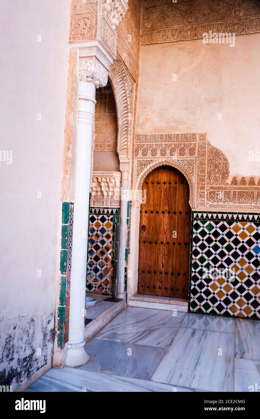 Geometric tile patterns, arabesque and elaborate calligraphic inscriptions at the Alhambra, Granada, Spain. Stock Photo
