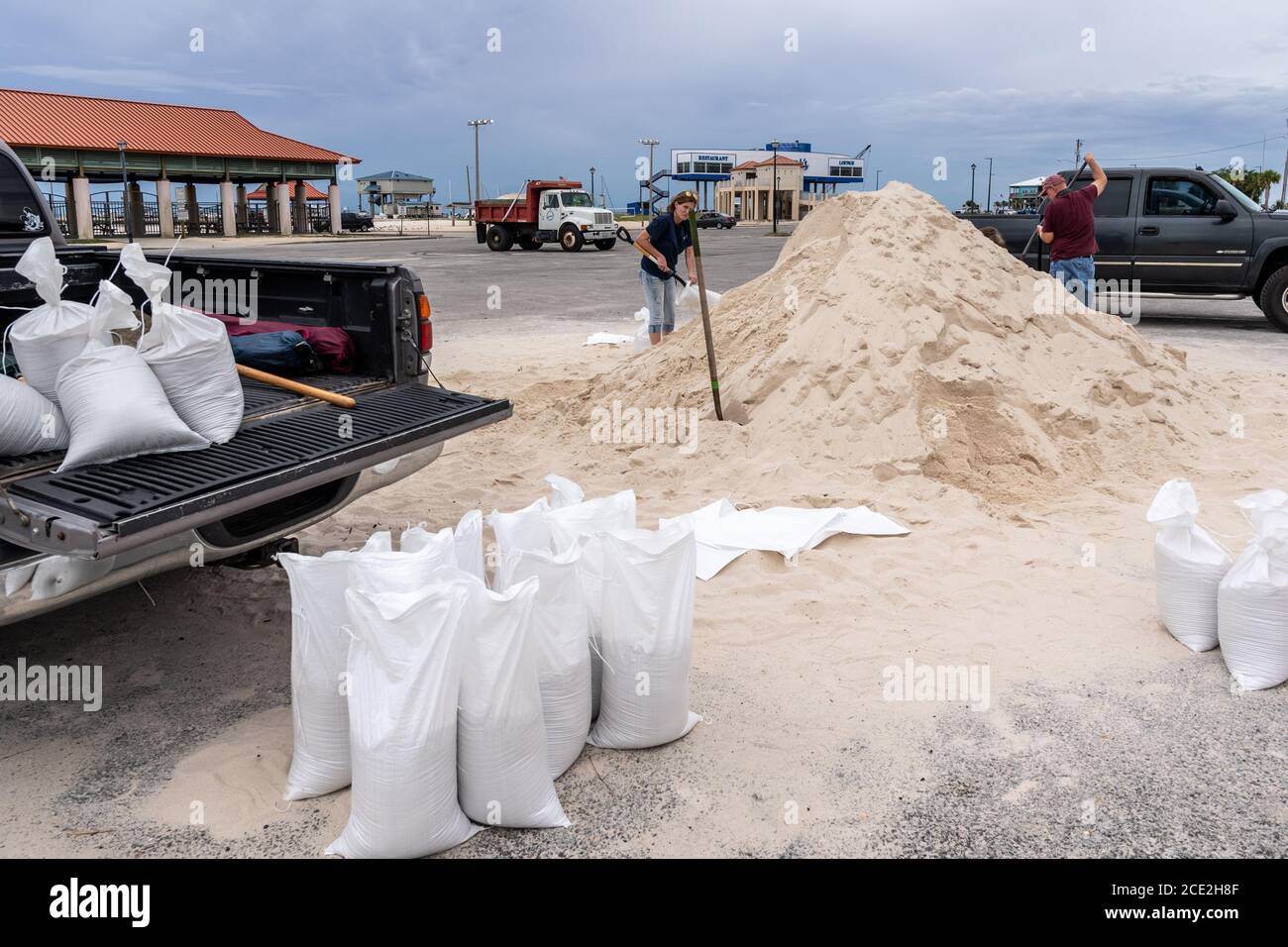 Mississippi Gulf Coast residents filling sandbags at a sandbag station