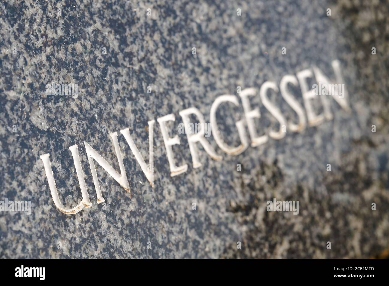 Gravestone in a cemetery with the word unforgotten Stock Photo