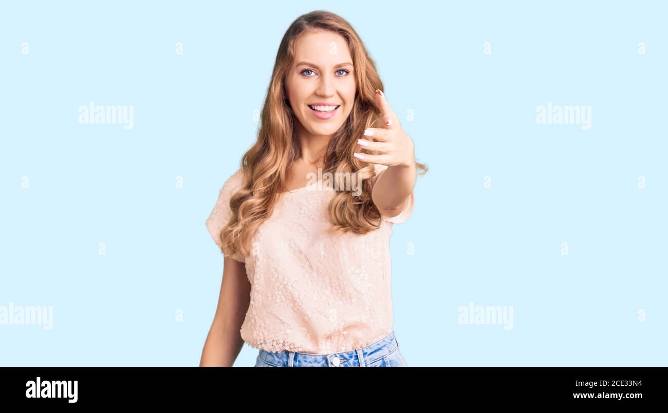 Happy blonde woman shaking long hi-res stock photography and images - Alamy