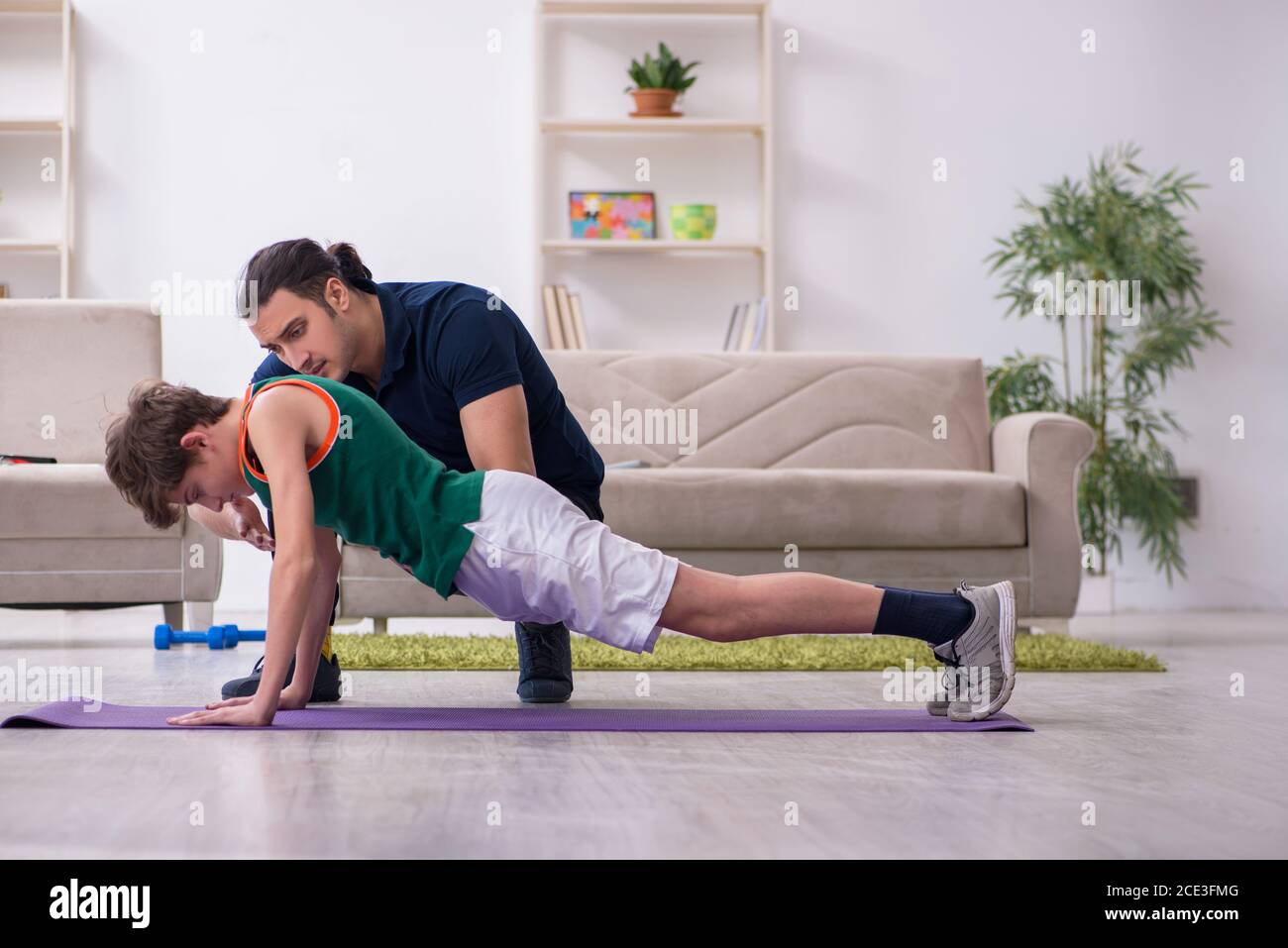 Father and son doing sport exercises at home Stock Photo - Alamy