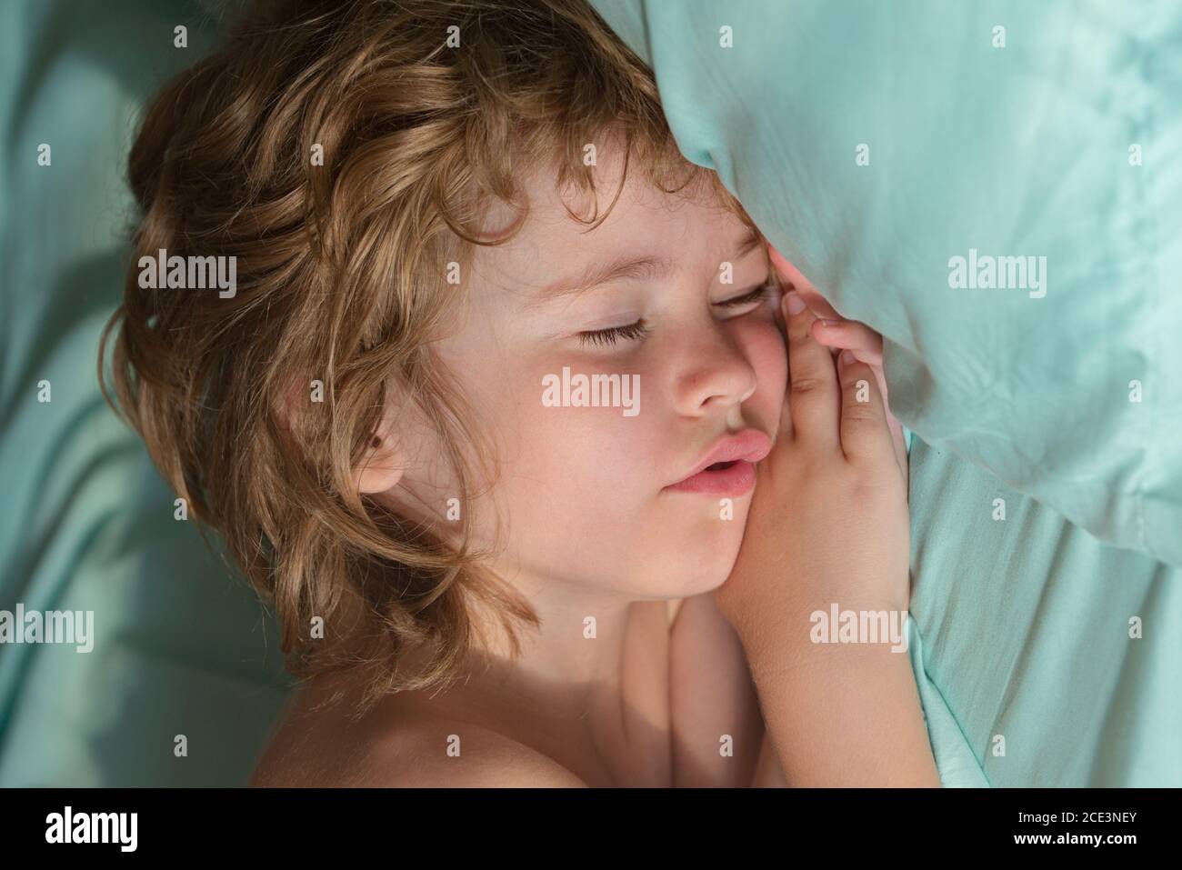 Little kids sleeping with her mouth open, snoring, kids sleeps in bed Stock Photo