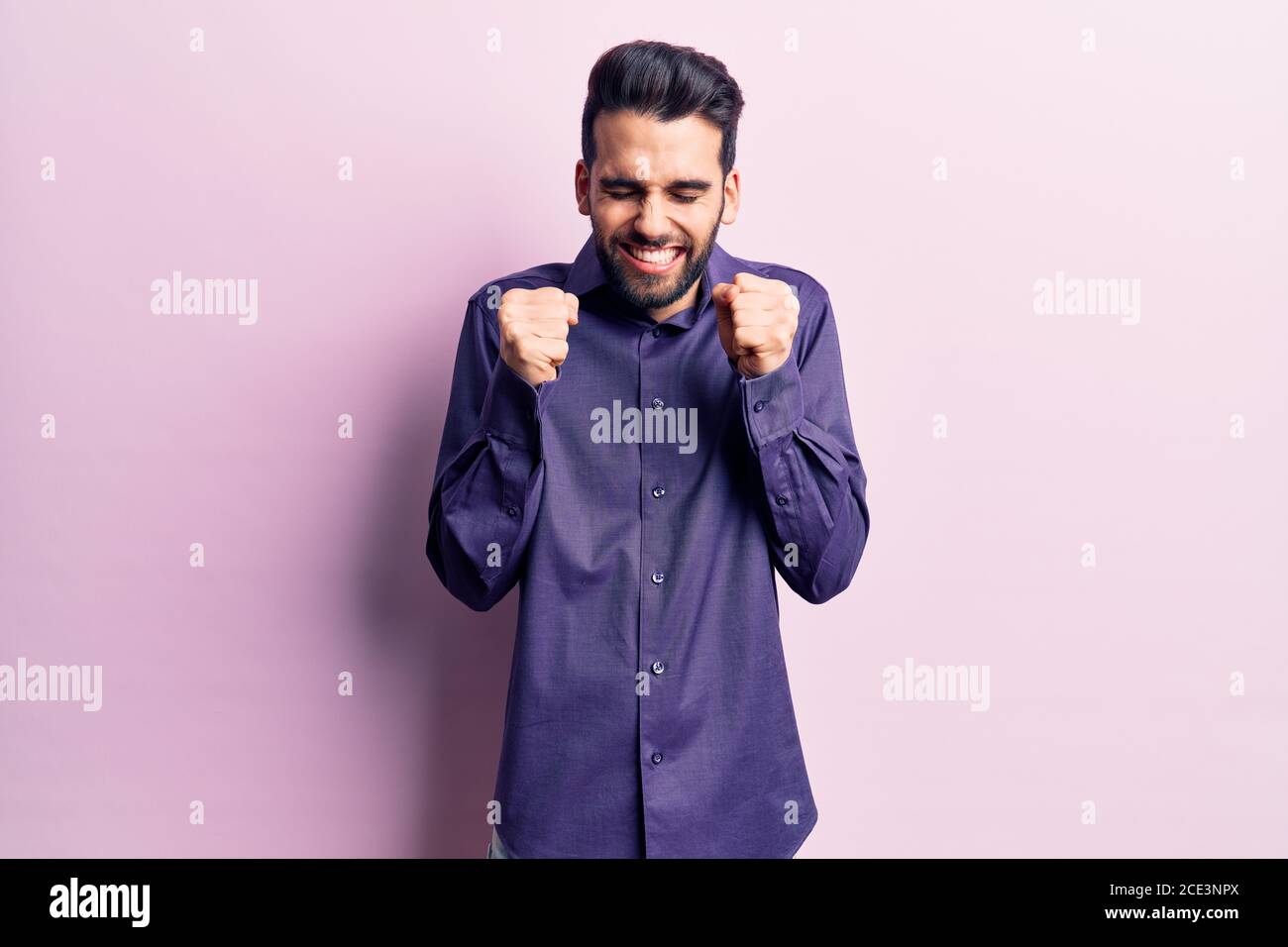 Young handsome man with beard wearing casual shirt excited for success ...