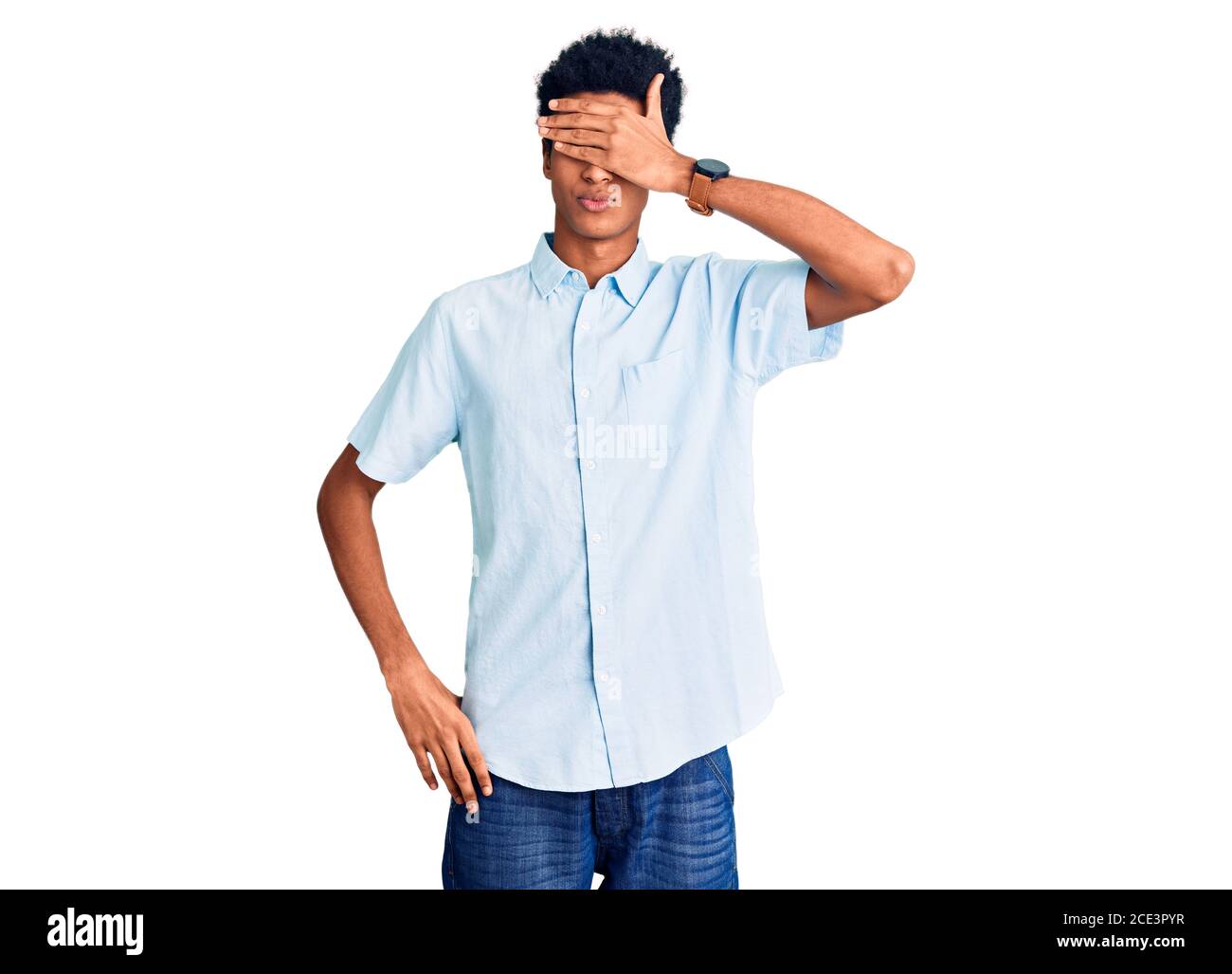 Young african american man wearing casual clothes covering eyes with ...