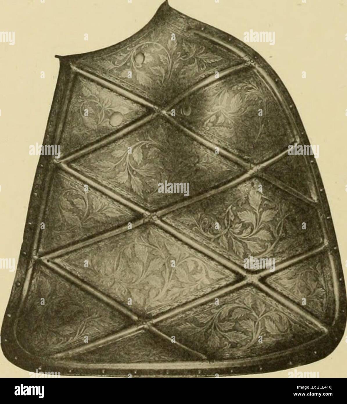 . Inventory and survey of the armouries of the Tower of London . Vth-XVIth Century). The lower half of the vambrace and the plate protecting the bend of thearm being fluted. The elbow-cop is of four plates, the central of whichis sharply pointed over the elbow, and the front plate has a dentated edge. 865. Mentonniere of George Clifford, Earl of Cumberland (LateXVIth Century), unfinished. The rose, thistle and fleur-de-lys are broadlyrecessed, but no engraving has been executed. The completed design fromthe armour appears on Plate XX. of the Armourers Album, Victoria andAlbert Museum. i68 THE Stock Photo