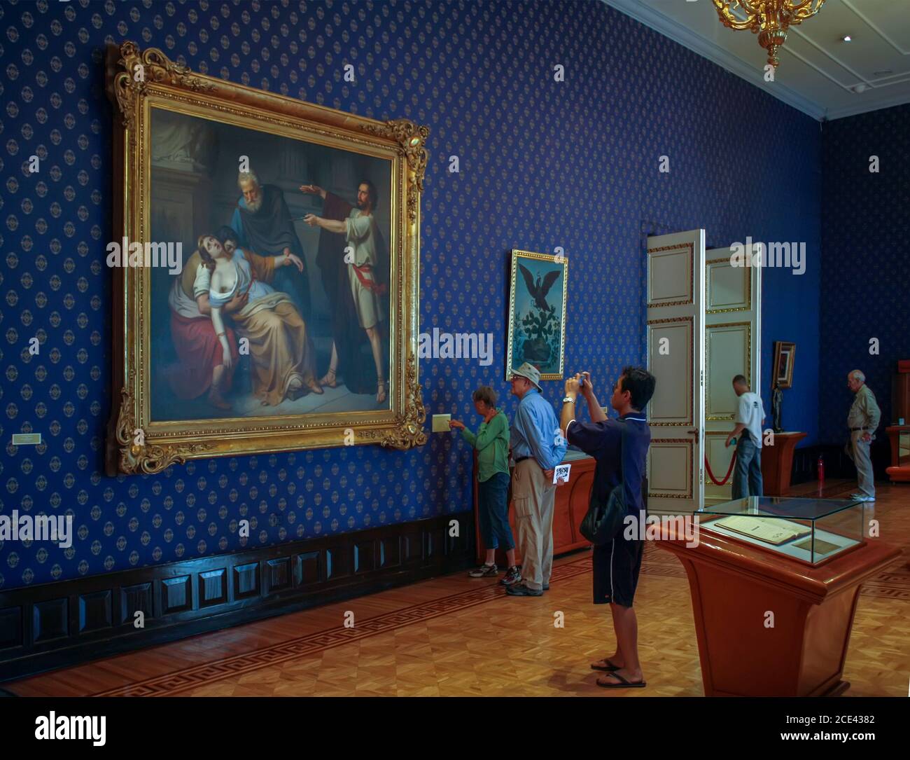 People viewing paintings in the National Palace, Mexico City, Mexico Stock Photo