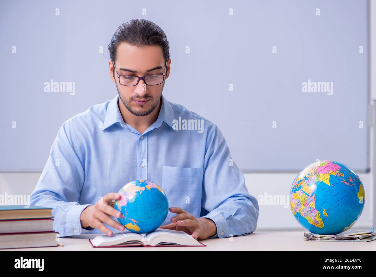 Young geography teacher in front of whiteboard Stock Photo Alamy