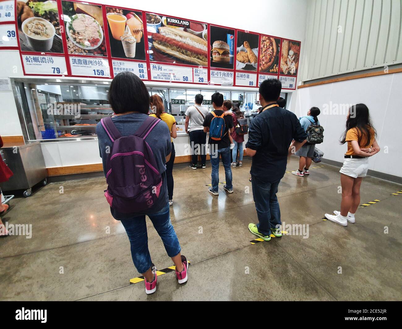 Hsinchu / Taiwan - August 28, 2020: Asian customers queuing keeping safe social distance at Costco supermarket restaurant Stock Photo