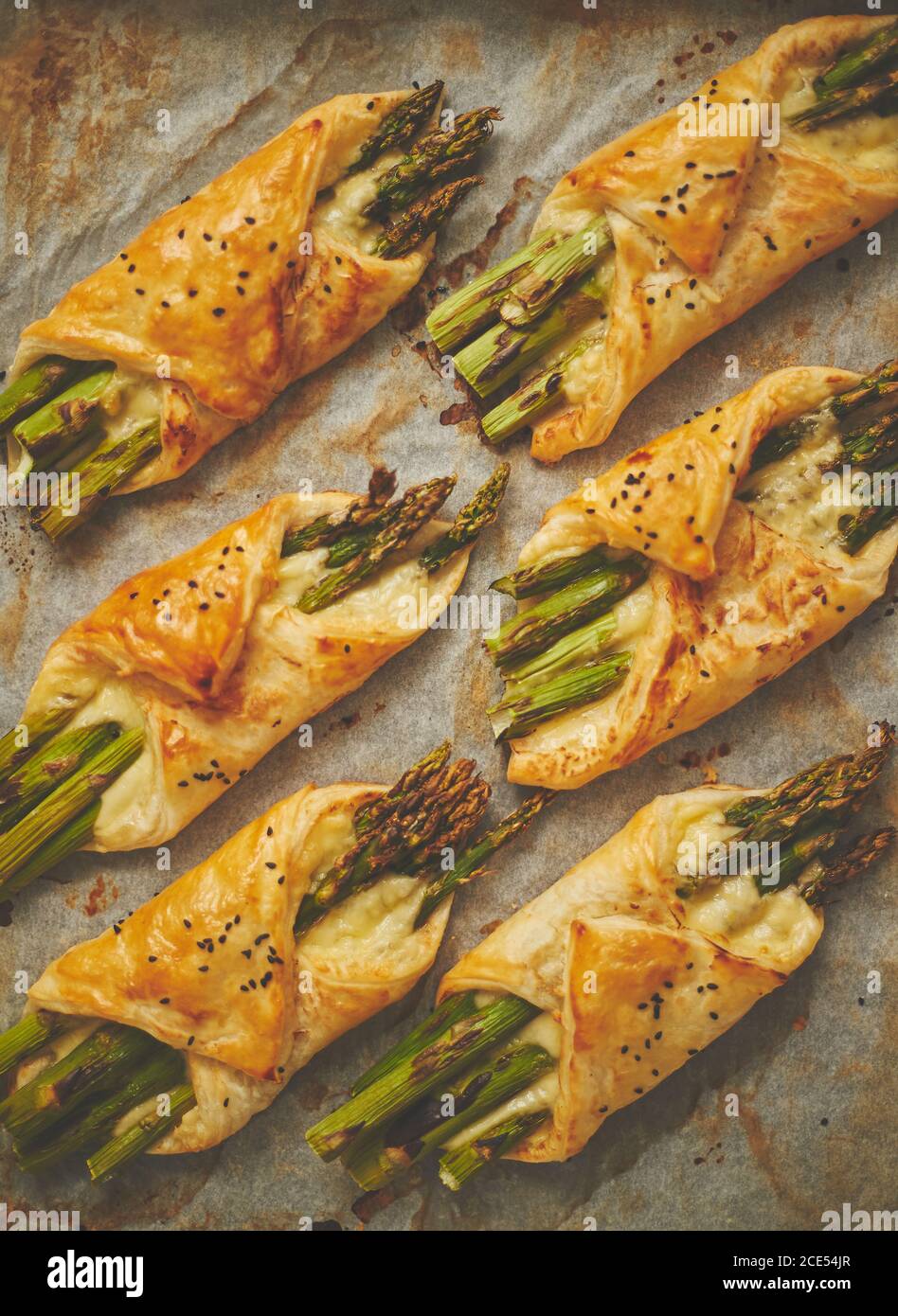 Baked green asparagus in puff pastry sprinkled with sesame seeds