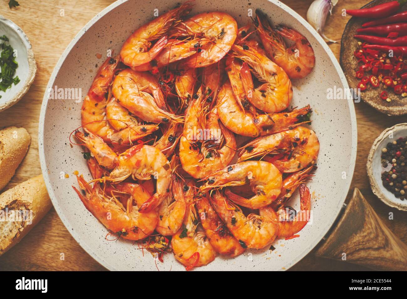 Traditional fried tiger prawn with garlic bread as top view served in a
